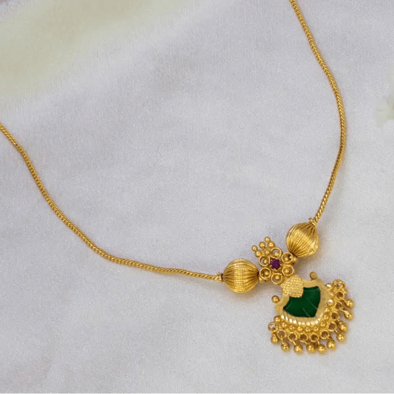 Gold-Plated Green Palakka Pendant Necklace featuring intricate gold-tone design and rich green palakka stone.