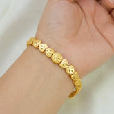 Gold-Plated Heart Urvasi Chain Bracelet displayed on a wrist, featuring heart-shaped charms and a stylish mesh chain.