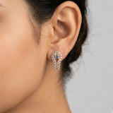 Gold Plated Purple CZ Stone Stud Earrings featuring CZ stones in a horseshoe design, showcased on an ear.