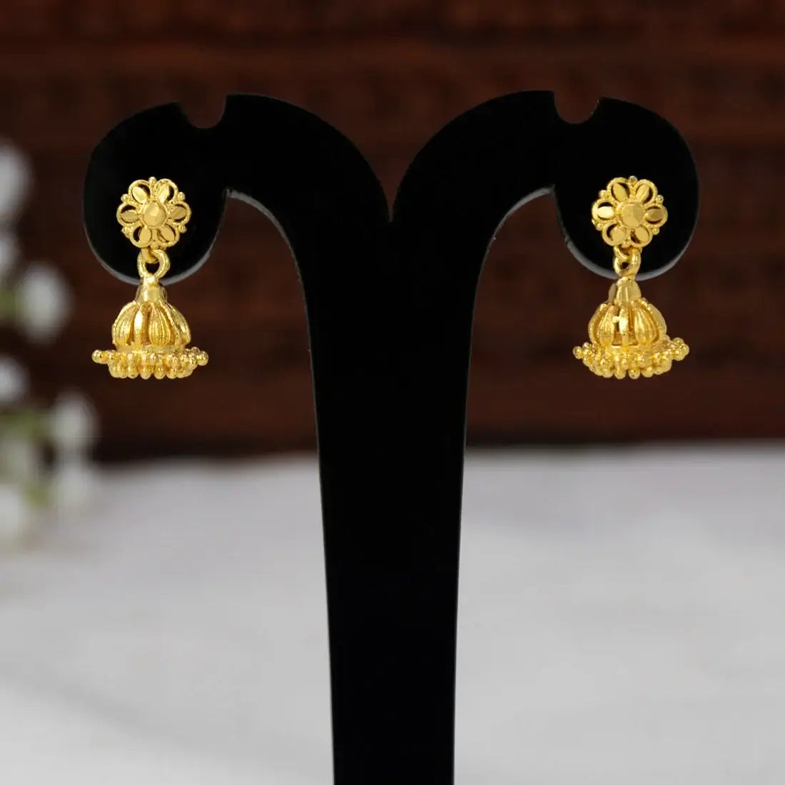 Gold Plated Simple Small Kids Jhumka Earrings hanging elegantly on display.