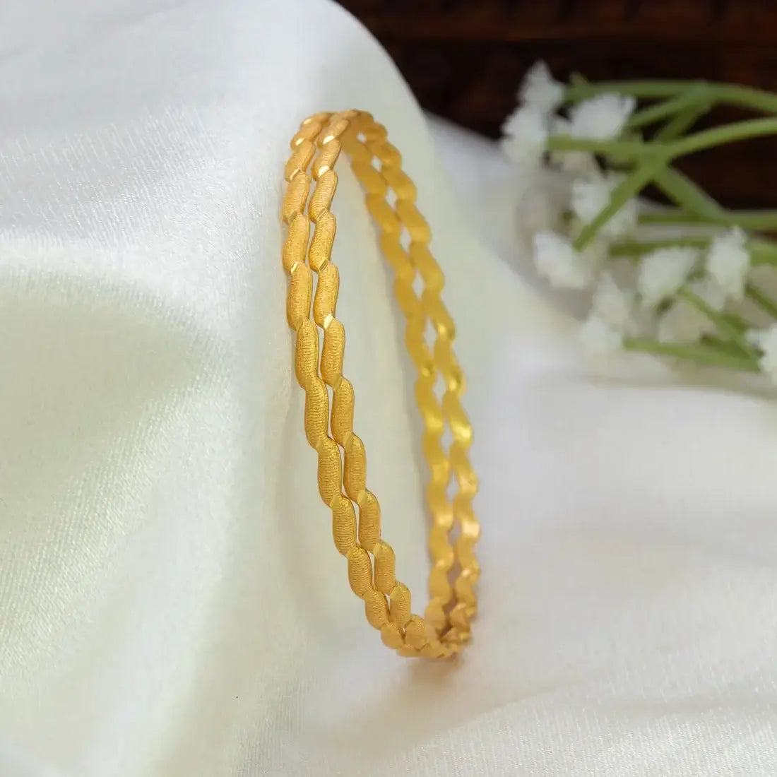 Gold-Plated Designer Bangles – Elegant Textured Gold Bangles showcasing interlinked patterns and fine texture.
