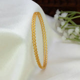 Gold-Plated Matte Thin Wave Bangles showcasing a delicate wavy ripple pattern on a soft fabric background.