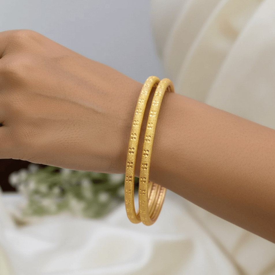 Gold Plated Simple Pipe Bangles worn on hand, showcasing elegant tubular design with subtle sparkling texture.