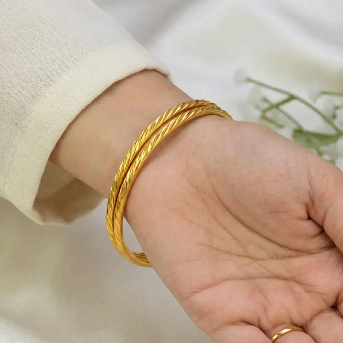 Gold Plated Spiral Cut Design Bangles showcased on a hand, highlighting their textured design and elegance.
