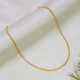 A Gold-Plated Sonali Chain for Babies & Kids draped in a U-shape on a soft, off-white textured fabric background.