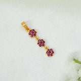 A Gold-Plated Three-tier Stone Floral Drop Pendant featuring three small ruby flower clusters connected in a vertical dangle design, displayed on a textured white fabric background.
