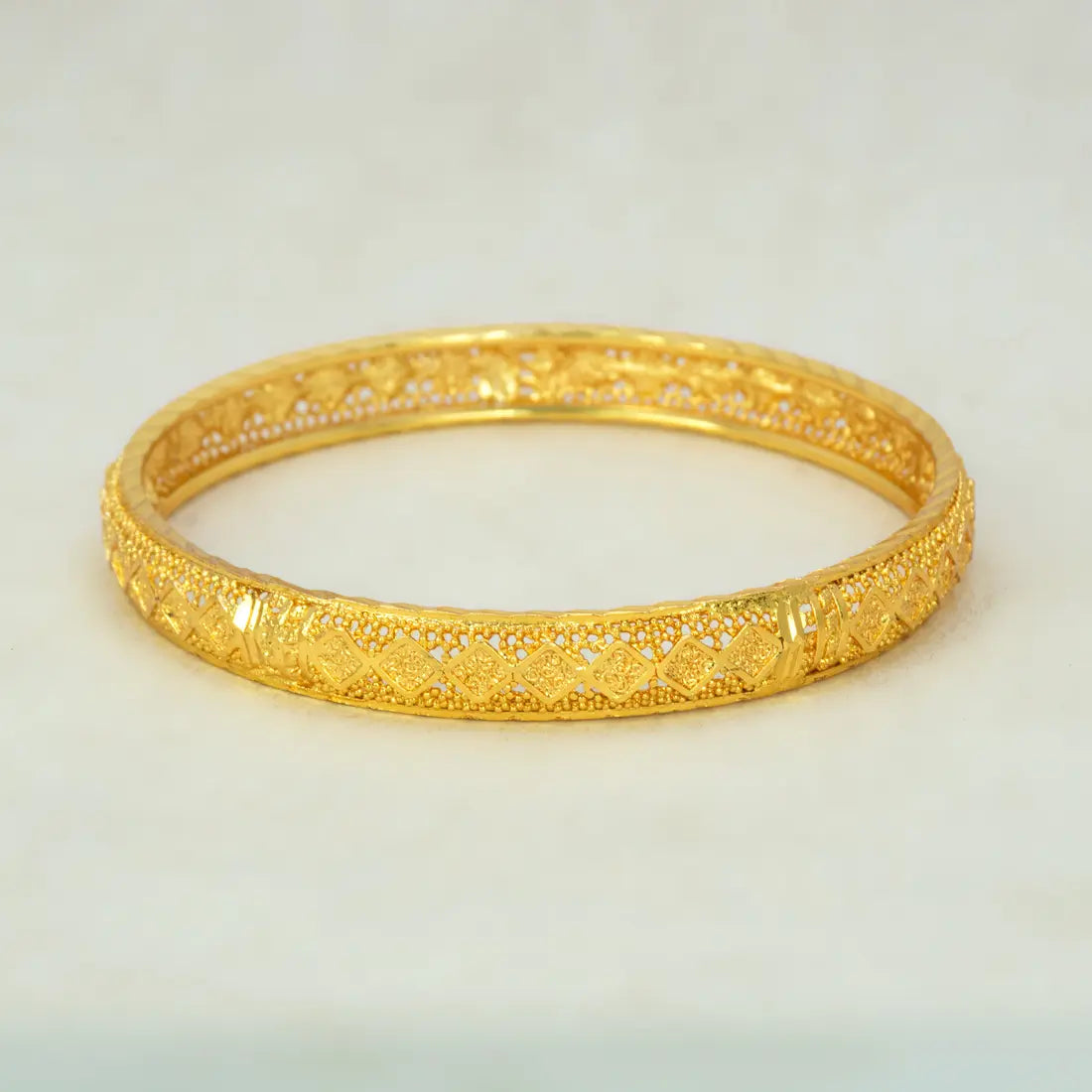 Gold Plated Mesh Diamond Design Net Bangle featuring intricate diamond-cut detailing and a delicate mesh pattern.