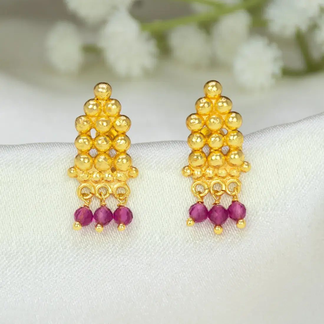 Gold Plated Crystal Hanging Beaded Studs featuring gold beads and ruby-red crystal dangles.