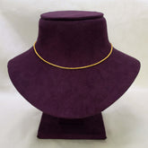 A Gold Plated Cutting Design Baby Chain necklace displayed on a purple velvet jewelry bust against a light off-white background.