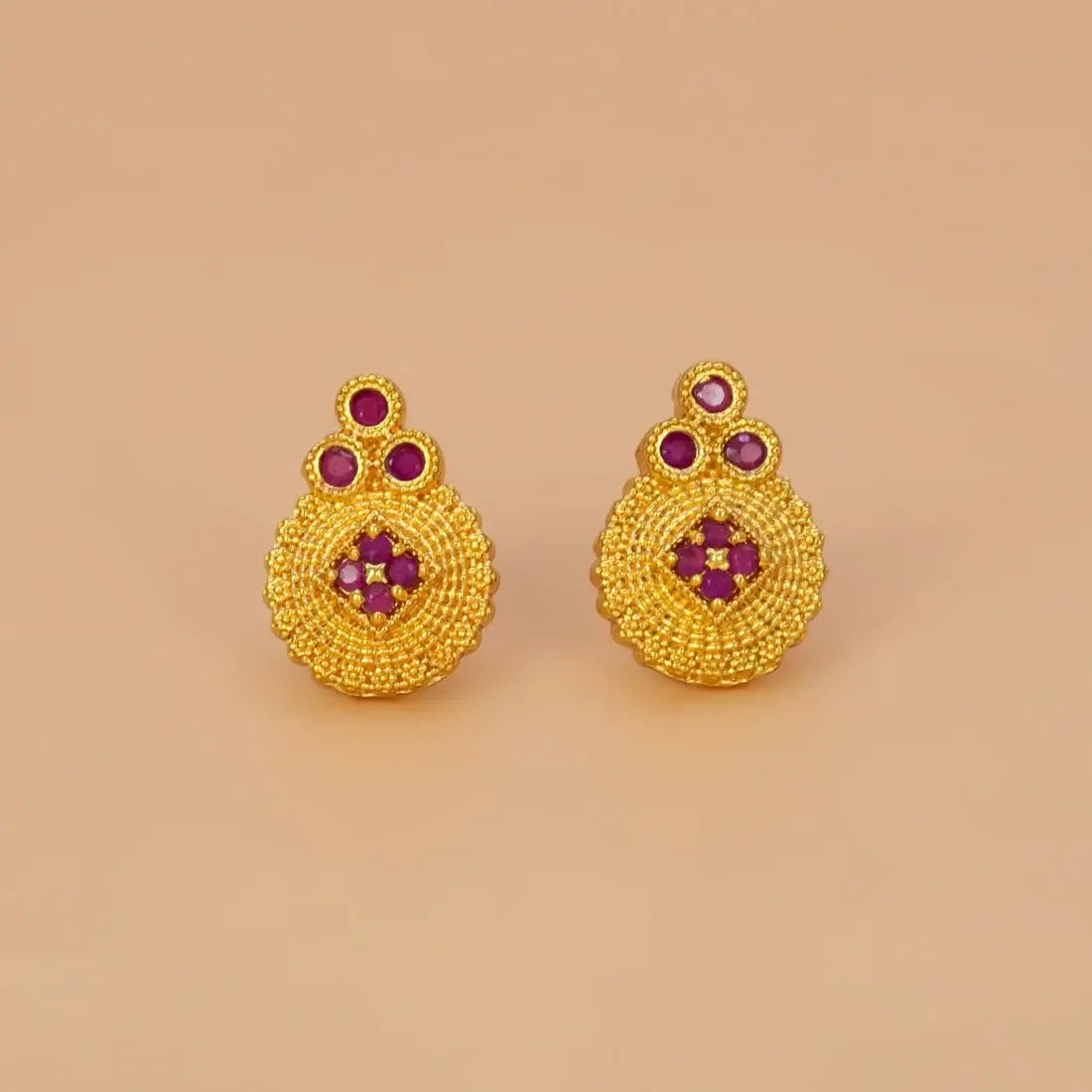 Gold Plated Floral Stone Studded Stud Earrings featuring textured gold and ruby stones.