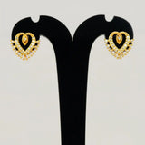 Dazzling Gold Plated Stone Heart Stud Earrings displayed on a black stand, showcasing sparkling layered heart design.