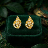 Gold Plated Leaf Model Stone Stud Earrings showcasing a leaf design with vibrant stones on a green velvet background.