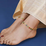 Gold Plated Square-Cut Multi-colour Stone Anklets worn elegantly on a model's feet.
