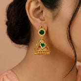 Small Premium Gold Plated Ruby Green Mango Jhumka worn by a model, featuring intricate gold detailing and vibrant green motifs.