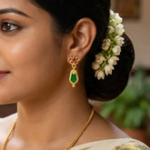 Gold Plated Green Nagapadam Floral Stud Drop Earrings worn by a woman with floral hairstyle.