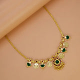 South Indian Green Palakka Lakshmi Kasu Necklace featuring emerald gems and Goddess Lakshmi coin drops on a gold chain.