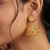 Gold Plated Kasu Lakshmi Ruby Stone Jhumka Earrings showcased on a model's ear, highlighting intricate craftsmanship.
