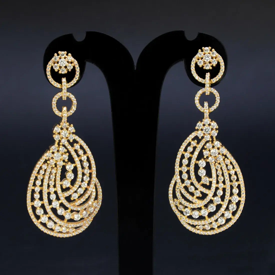 Layered Swirl CZ Stone Drop Earrings featuring swirling gold design and sparkling cubic zirconia stones.