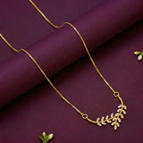 Gold Plated American Diamond Leaf Pendant Necklace displayed on a dark surface with elegant design and cubic zirconia accents.