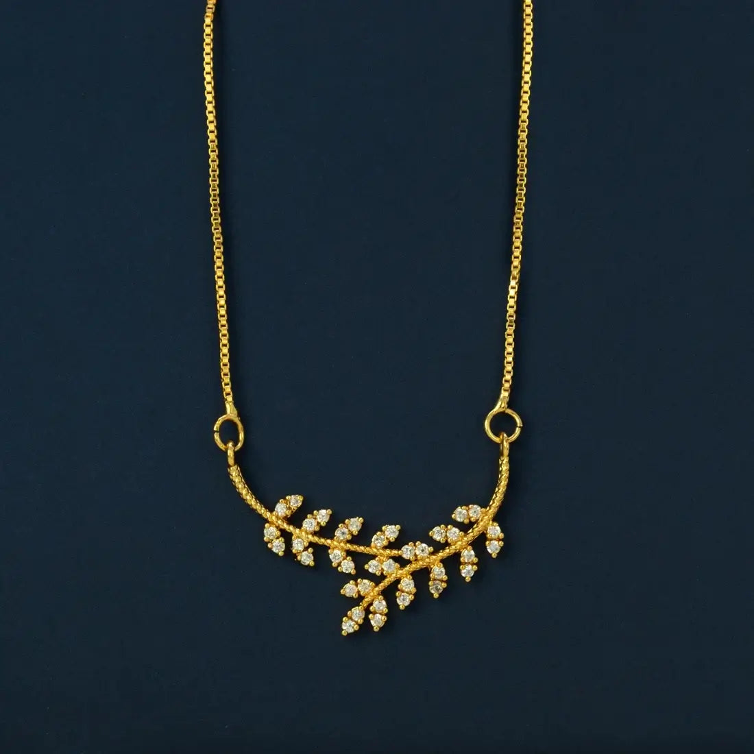 Gold Plated American Diamond Leaf Pendant Necklace showcasing a sparkling leaf branch with cubic zirconia stones.