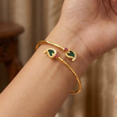 Kerala Traditional Mango Motif Open Bangle Bracelet featuring mango motifs and ruby stones on a gold-plated brass base.