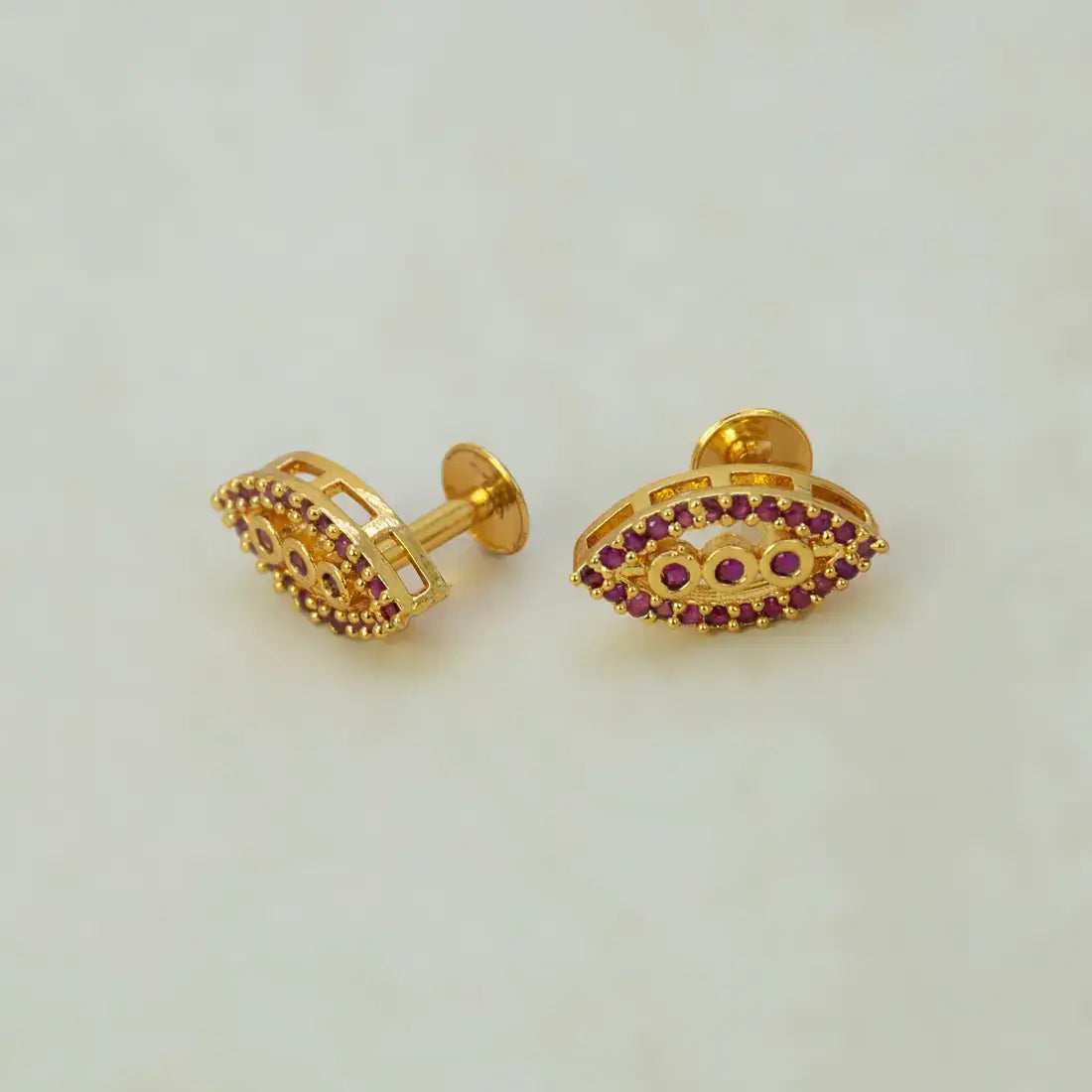 Marquise Ruby Stone Gold-plated Stud Earrings featuring graduated ruby stones and elegant gold-plated design.