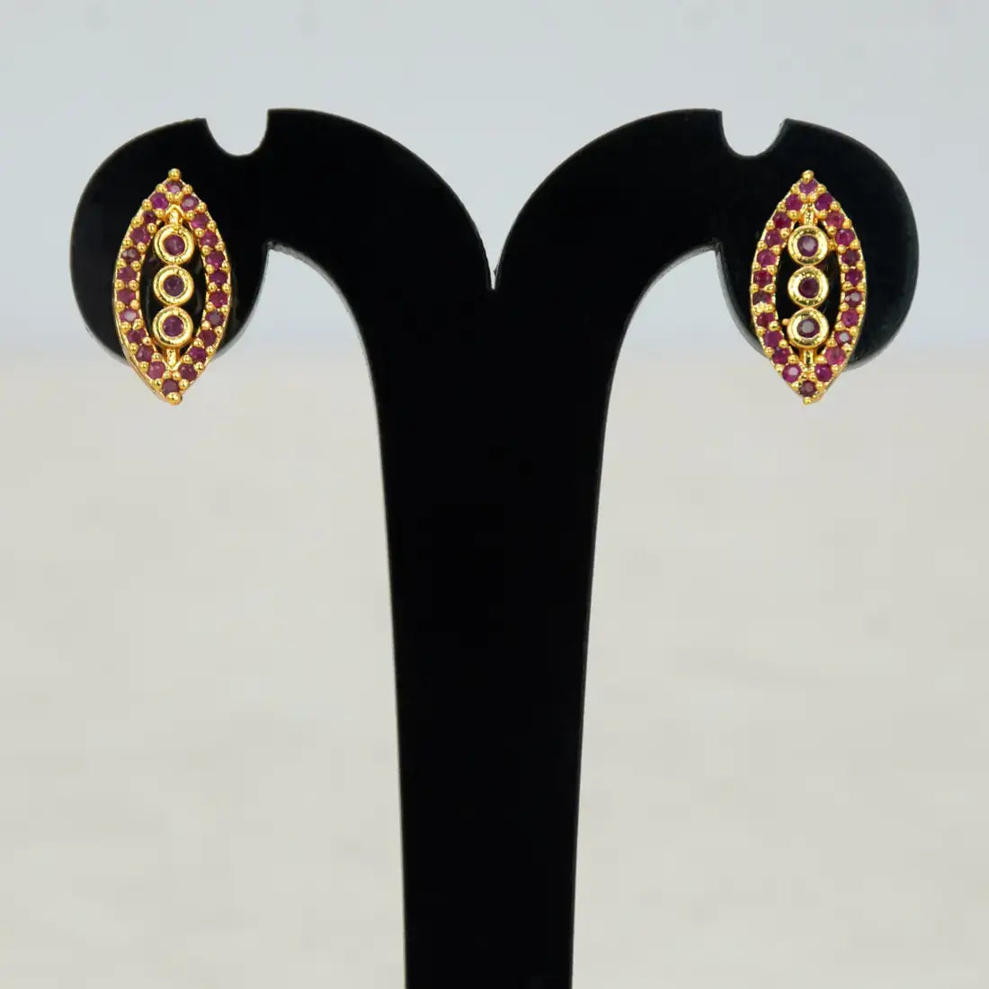 Marquise Ruby Stone Gold-plated Stud Earrings featuring three graduated ruby stones in a classic eye shape.