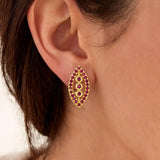 Marquise Ruby Stone Gold-plated Stud Earrings on model's ear, featuring synthetic ruby stones in classic design.