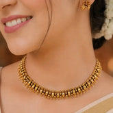 Antique Gold Beaded Elakkathali Choker Necklace Set showcased on a model, highlighting intricate beaded design and elegance.