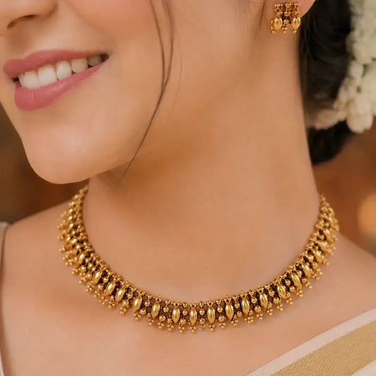 Antique Gold Beaded Elakkathali Choker Necklace Set showcased on a model, highlighting intricate beaded design and elegance.