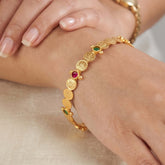 Sleek Lakshmi Kasu Multi-Colour Kemp Stone Bangle with gold plating and colorful stones on a wrist.