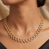 Gold Plated Oval CZ Stone Necklace worn with elegance showcasing its sparkling cubic zirconia stones.