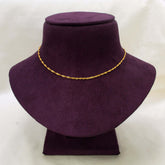 A delicate Popular Gold-Plated Twisted Singapore Chain displayed on a dark purple velvet jewelry bust against a light off-white background.