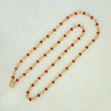 South Indian Coral Red and Golden Beaded Chain featuring textured gold-plated beads and coral red accents.