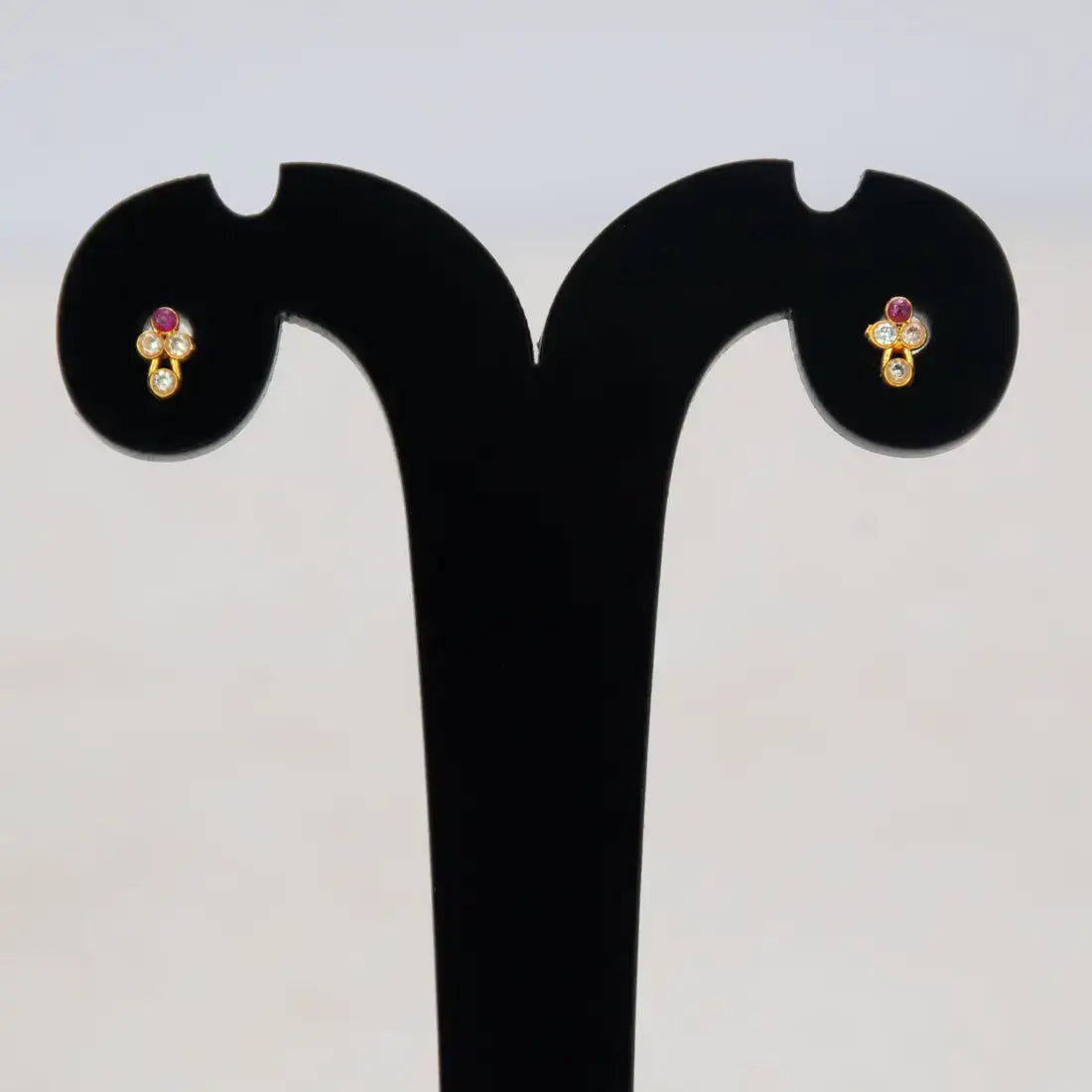 Cute Stone Studs for Second Lobe displayed on a stand with a floral design and sparkling stones.