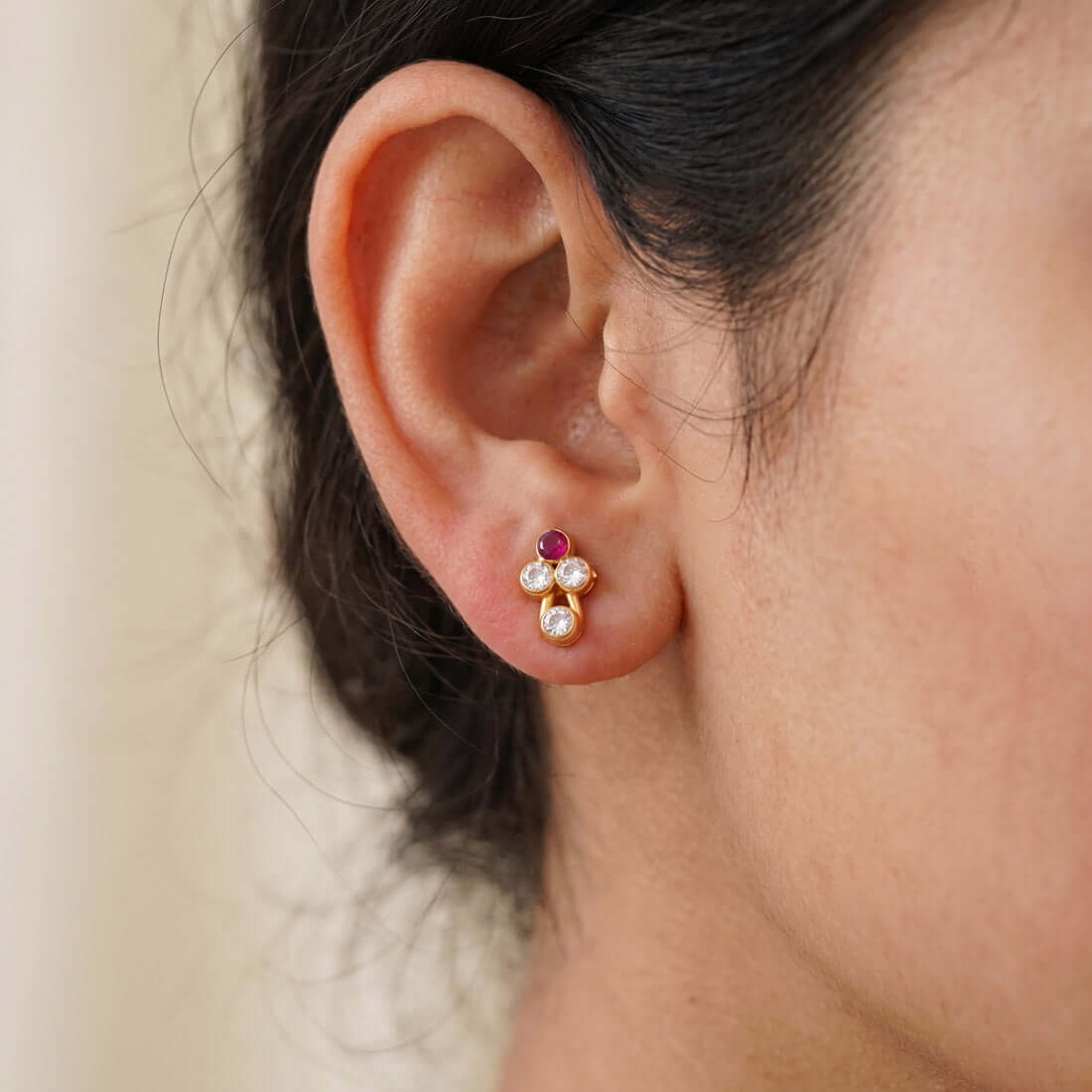 Cute Stone Studs for Second Lobe showcased on a model's ear, featuring a floral design and sparkling stones.