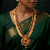 Gold-Plated Stone Lakshmi Kasu Haram Necklace worn by a model in a traditional green saree.