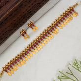 Kemp Stone Antique Gold Plated Elakkathali Necklace Set featuring vibrant kemp stones and gold leaf drops.