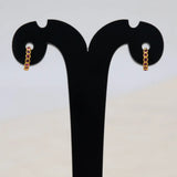 Gold Plated Stone Hoop Earrings for Women showcasing elegant ruby stones on a display stand.