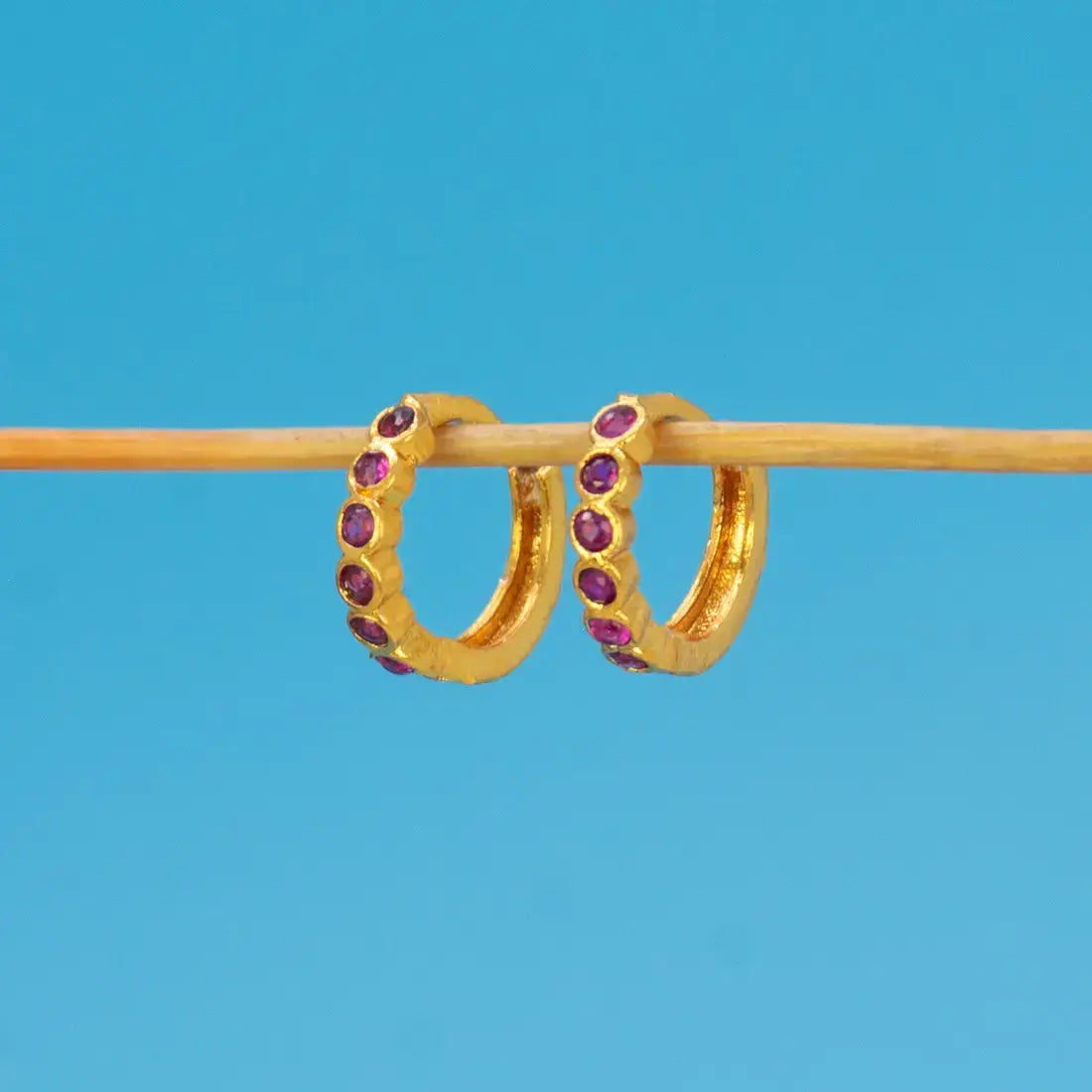 Gold Plated Stone Hoop Earrings for Women featuring purple stones set in a sleek gold finish.