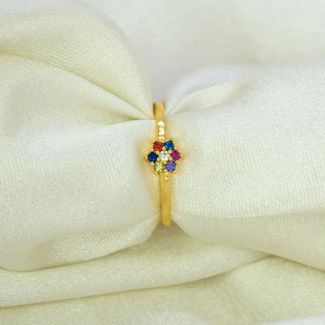Saptaratna Floral Stone Gold Plated Ring showcasing seven colored stones in a cluster on a gold band.