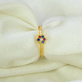 Saptaratna Floral Stone Gold Plated Ring showcasing seven colored stones in a cluster on a gold band.