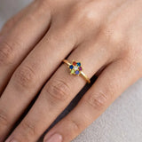 Saptaratna Floral Stone Gold Plated Ring displayed on a hand, showcasing the vibrant cluster of seven colored stones.