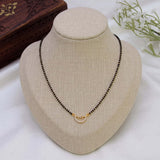 Simple CZ Stone Pendant Mangalsutra Necklace displayed on a jewelry stand with a black bead chain and a gold accent.