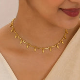 Gold Plated Wavy Chain Elakkathali Necklace with leaf charms, showcasing an elegant design worn around the neck.