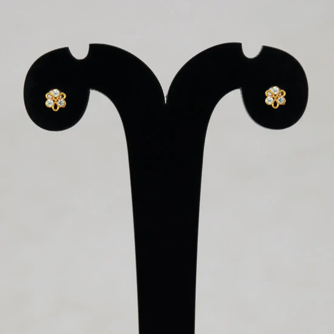 Simple Stone Flower Studs for Second Lobe & Kids displayed on an earring stand featuring a floral design.