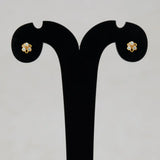 Simple Stone Flower Studs for Second Lobe & Kids displayed on an earring stand featuring a floral design.