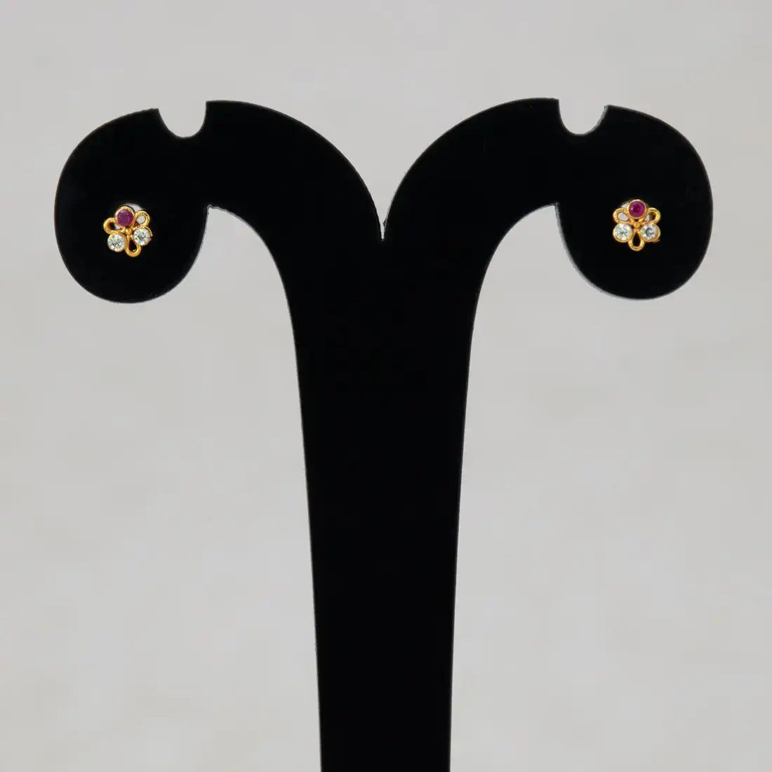 Simple Stone Flower Studs for Second Lobe & Kids displayed on earring stand, featuring three-petal floral design with sparkling stones.