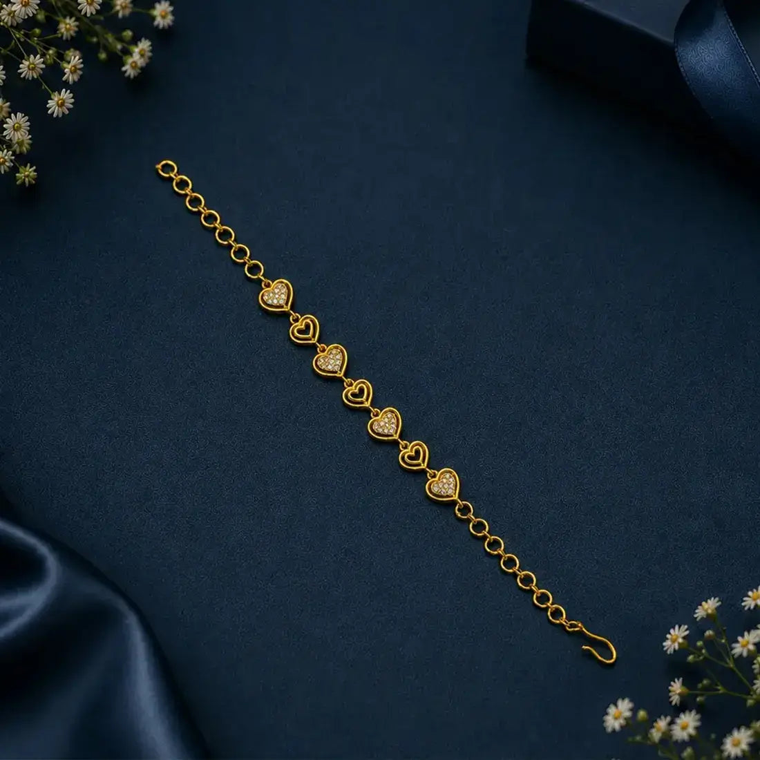 Gold Plated Stones and Outline Heart Bracelet featuring alternating heart links with sparkling stones.