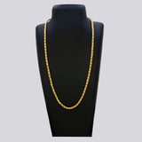 Gold chain necklace on a black mannequin bust against a gray background